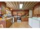 Kitchen with wood cabinets, tile floor and laundry area at 3781 Narmore Ne Dr, Atlanta, GA 30319