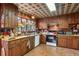 Rustic kitchen with wood cabinets, tile floors and a plaid ceiling at 3781 Narmore Ne Dr, Atlanta, GA 30319