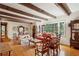 Living area with hardwood floors, exposed beams, and a view of the backyard at 3781 Narmore Ne Dr, Atlanta, GA 30319