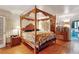 Main bedroom with four-poster bed, hardwood floors, and access to bath at 3781 Narmore Ne Dr, Atlanta, GA 30319