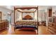 Spacious main bedroom with wooden four-poster bed and hardwood floors at 3781 Narmore Ne Dr, Atlanta, GA 30319