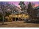 View of the backyard with deck and yard, providing an outdoor entertaining space with mature trees and landscaping at 490 Rock Springs Ne Rd, Atlanta, GA 30324