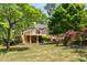 A backyard view of a home with a new deck overlooking a well-maintained lawn and mature trees, creating a peaceful outdoor space at 490 Rock Springs Ne Rd, Atlanta, GA 30324