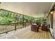 Covered deck with seating area and view of lush greenery at 490 Rock Springs Ne Rd, Atlanta, GA 30324