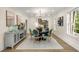 Dining room with a modern chandelier, seating for six, and light-filled windows at 490 Rock Springs Ne Rd, Atlanta, GA 30324