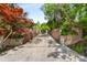 A long, paved driveway leading up to a gated entrance, flanked by lush landscaping and mature trees at 490 Rock Springs Ne Rd, Atlanta, GA 30324