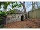 Exterior of charming stone structure with arched entrance, surrounded by lush greenery and mature trees at 490 Rock Springs Ne Rd, Atlanta, GA 30324