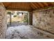 The interior of the stone garage features exposed brick walls and a concrete floor, showcasing its rustic charm at 490 Rock Springs Ne Rd, Atlanta, GA 30324
