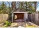 Charming stone garage with open doors, surrounded by lush greenery and mature trees, enhances the property's appeal at 490 Rock Springs Ne Rd, Atlanta, GA 30324