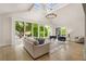 Open-concept living room with a vaulted ceiling, skylights, hardwood floors, and large windows at 490 Rock Springs Ne Rd, Atlanta, GA 30324