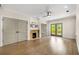 Spacious main bedroom featuring hardwood floors, a fireplace, and sliding doors to a balcony at 490 Rock Springs Ne Rd, Atlanta, GA 30324