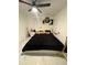 Modern bedroom with a black-patterned comforter and a ceiling fan, perfect for relaxation at 1876 Connally Dr, East Point, GA 30344