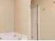 Bathroom with corner tub, glass shower, and neutral tile at 566 Maggie Ln, Jonesboro, GA 30238