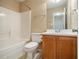 Clean bathroom with a tub, toilet and wood vanity at 566 Maggie Ln, Jonesboro, GA 30238