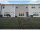 Rear view of the house showing a patio and lawn at 566 Maggie Ln, Jonesboro, GA 30238
