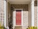 Red front door entry to brick townhouse at 566 Maggie Ln, Jonesboro, GA 30238