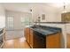 Kitchen features a breakfast bar, dark countertops, and stainless steel appliances at 566 Maggie Ln, Jonesboro, GA 30238