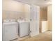Convenient laundry room with washer, dryer, and shelving at 566 Maggie Ln, Jonesboro, GA 30238