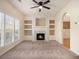 Living room with fireplace, built-ins, and carpet at 566 Maggie Ln, Jonesboro, GA 30238