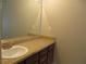 Bathroom with vanity, granite countertop and dark brown cabinets, offering ample storage at 9400 Roberts Dr # 1C, Atlanta, GA 30350