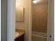 Clean bathroom with beige tile and a built-in vanity at 9400 Roberts Dr # 1C, Atlanta, GA 30350