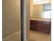 Bathroom with vanity, granite countertop, and a large mirror, offering ample storage at 9400 Roberts Dr # 1C, Atlanta, GA 30350
