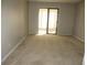 Well-lit bedroom with sliding glass doors opening to an outdoor area and neutral carpeting at 9400 Roberts Dr # 1C, Atlanta, GA 30350