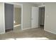 Well-lit bedroom with mirrored closet doors and neutral carpeting at 9400 Roberts Dr # 1C, Atlanta, GA 30350