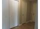 Hallway with multiple white built in closets at 9400 Roberts Dr # 1C, Atlanta, GA 30350