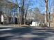Exterior of condo building with parking lot and landscaping at 9400 Roberts Dr # 1C, Atlanta, GA 30350