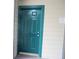 Teal front door to condo unit with warning sign at 9400 Roberts Dr # 1C, Atlanta, GA 30350