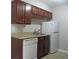 Modern kitchen with granite countertops, wood cabinets, and stainless steel appliances at 9400 Roberts Dr # 1C, Atlanta, GA 30350
