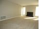 Spacious living room showcasing a fireplace and large windows at 9400 Roberts Dr # 1C, Atlanta, GA 30350