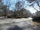 Residential street view showcasing homes and landscaping at 9400 Roberts Dr # 1C, Atlanta, GA 30350