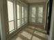 Sun-drenched sunroom with tile flooring and multiple windows at 9400 Roberts Dr # 1C, Atlanta, GA 30350