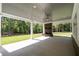 Covered patio with fireplace and ceiling fan, overlooking a grassy backyard at 1168 Harmony Dr, Canton, GA 30115