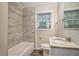 Renovated bathroom with a new bathtub and tile surround at 2224 Polar Rock Sw Ave, Atlanta, GA 30315