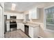 Modern kitchen with white cabinets, granite counters, and stainless steel appliances at 2224 Polar Rock Sw Ave, Atlanta, GA 30315