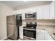 Stainless steel appliances and granite countertops in this updated kitchen at 2224 Polar Rock Sw Ave, Atlanta, GA 30315