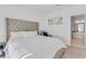 King-size bed, tufted headboard, and view into the bathroom at 525 Parkway Ne Dr # 404, Atlanta, GA 30354