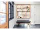 White brick entryway with built-in shelving and a mid-century modern bench at 1063 Ormewood Ave, Atlanta, GA 30316