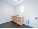 Functional laundry room with light wood cabinets and hexagon tile floor at 1063 Ormewood Ave, Atlanta, GA 30316