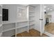 Bright white pantry with built-in shelving and hardwood floors at 74 Austin Ne Ave, Marietta, GA 30060