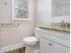 Updated bathroom with granite countertop, white vanity, and tile shower at 748 Amber Nw, Atlanta, GA 30331