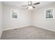 Bright bedroom with ceiling fan, neutral carpeting, and large windows at 748 Amber Nw, Atlanta, GA 30331