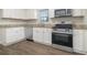 Modern kitchen with stainless steel appliances and wood-look flooring at 748 Amber Nw, Atlanta, GA 30331