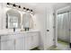 Stylish bathroom with double sinks and arched mirrors at 2528 Shropshire Pl, Mcdonough, GA 30253
