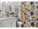 Clean bathroom with white vanity and floral shower curtain at 2528 Shropshire Pl, Mcdonough, GA 30253
