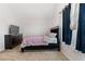 Bright bedroom with double bed, dresser, and window with curtains at 2528 Shropshire Pl, Mcdonough, GA 30253
