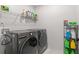 Convenient laundry room with washer, dryer, and storage at 2528 Shropshire Pl, Mcdonough, GA 30253